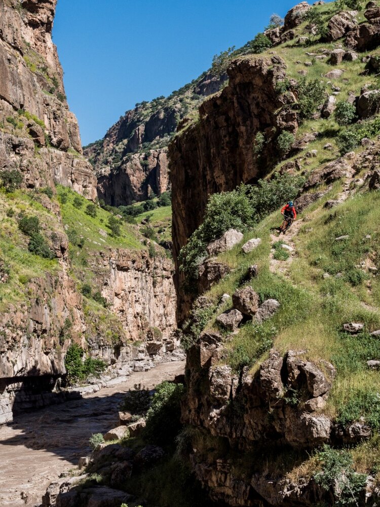 Naively none of the team expected northern Iraq to be so green. Surprisingly beautiful as it was, the tall spring grass obscured paths and made exploring trails, such as this one following the Rawanduz river, more difficult. Here, Eric Porter seizes on an open section of canyon trail above a river churning brown with snow melt.
