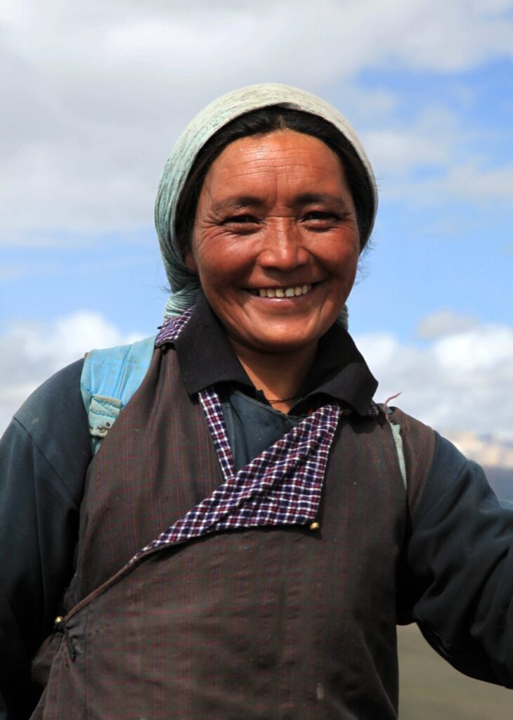Local woman, Nimaling meadows, north Zanskar. During the summer, Zanskari women and children go far from their villages to the high pastures to tend to the livestock (mainly sheep, goats and yak) in the ancient system of pastoralism known as transhumance.