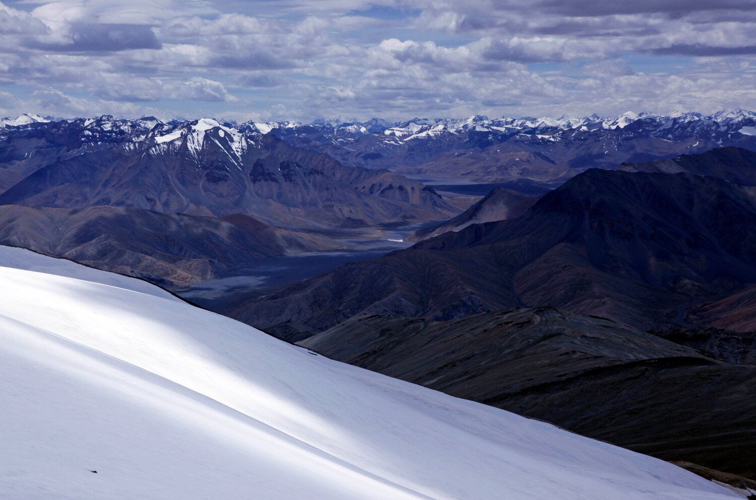 Silence and light: looking west into the heart of the Zanskar Range from the summit of Mentok II (6150 metres). The glacial valley visible in the centre of the image is around twenty-five miles long, and entirely uninhabited.