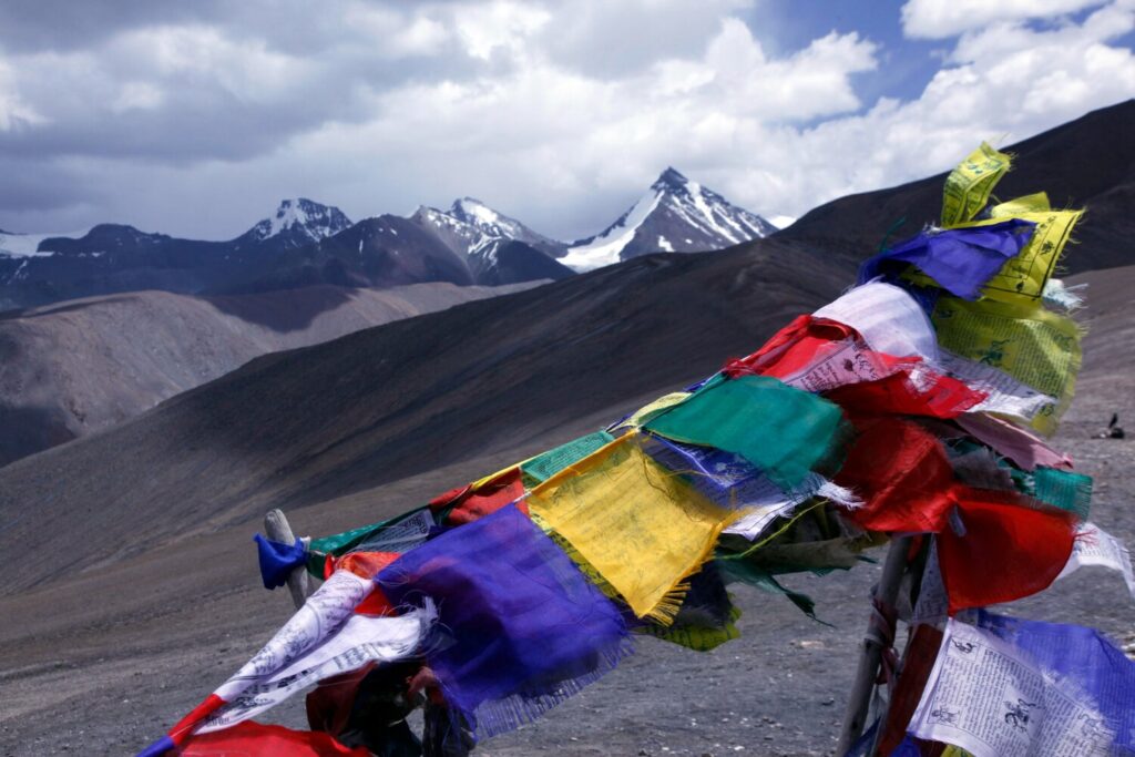 Prayer flags fly on the Zalung Karpo La (c5200 metres), a high pass under the Kang Yatze massif, north Zanskar