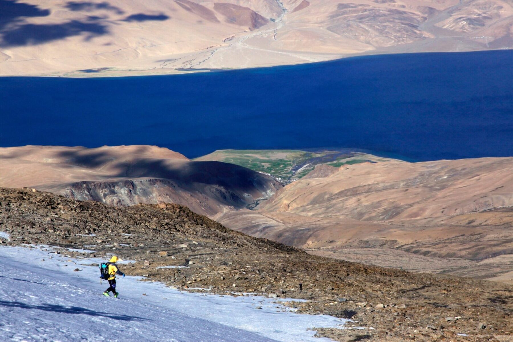 Descending from the summit of Mentok II (6,150m). The icy waters of Tso Mori lake far below.