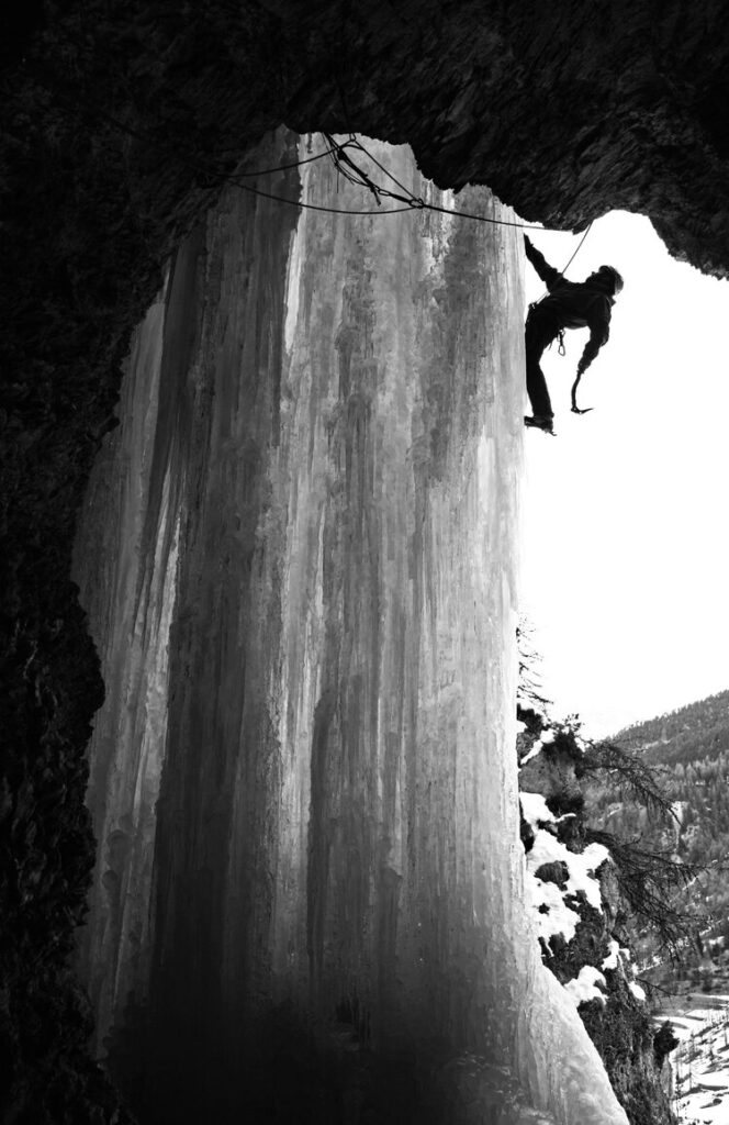 Giles Cornah moves out across the ice curtain on Prends Moi Sec (M7+) at Ceillac, a small but excellent ice and mixed climbing area in the Eastern Ecrins. This route follows a mixed line out of a large cave to eventually gain the ice pillar of the super-classic Sombre Heroes (WI5).