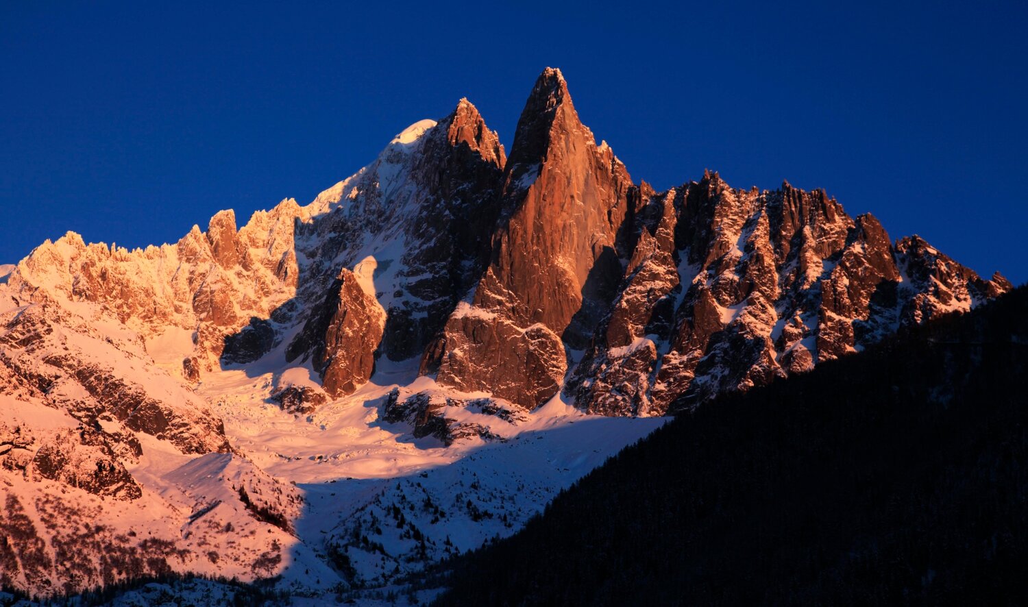 The Aiguille du Dru cast in sharp definition by the last few minutes of midwinter sunlight. In the centre of the Chamonix Valley, and looming over the great icefall climbs of the Argentiere Glacier, the Dru is a constant presence on any climbing trip in the region.