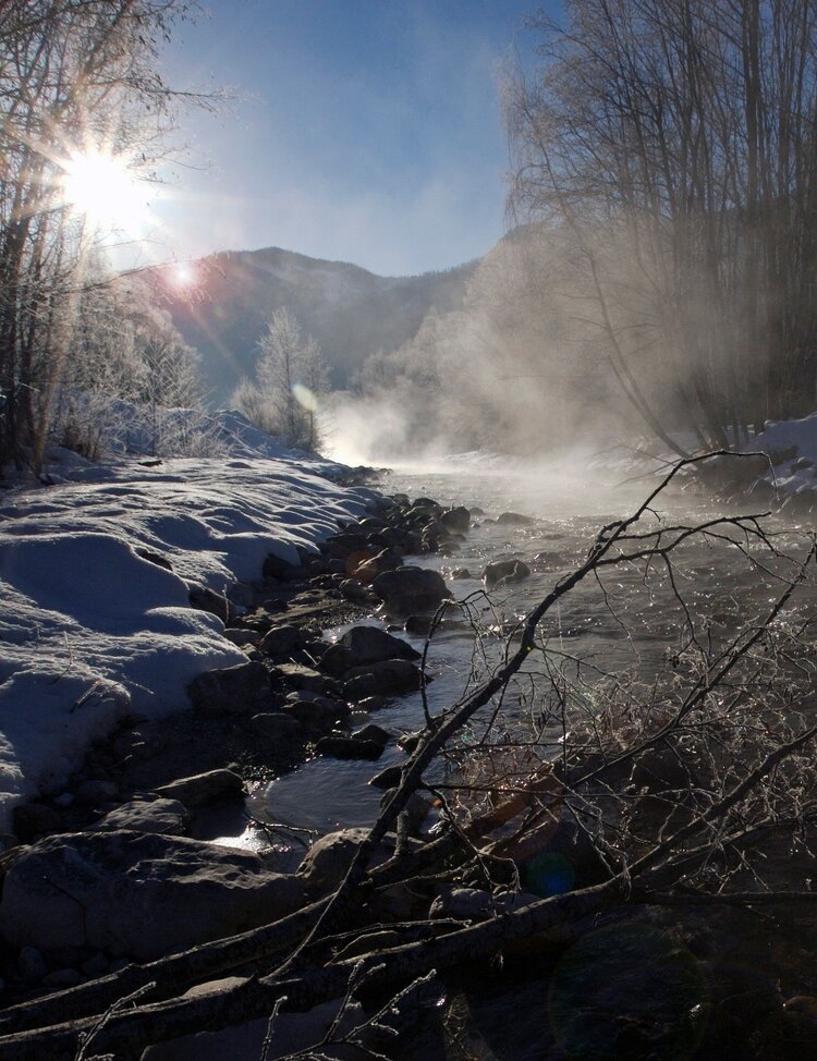Mist steaming of the river Gyronde in early morning winter light after a very hard frost, just downstream from the pretty alpine village of Vallouise.