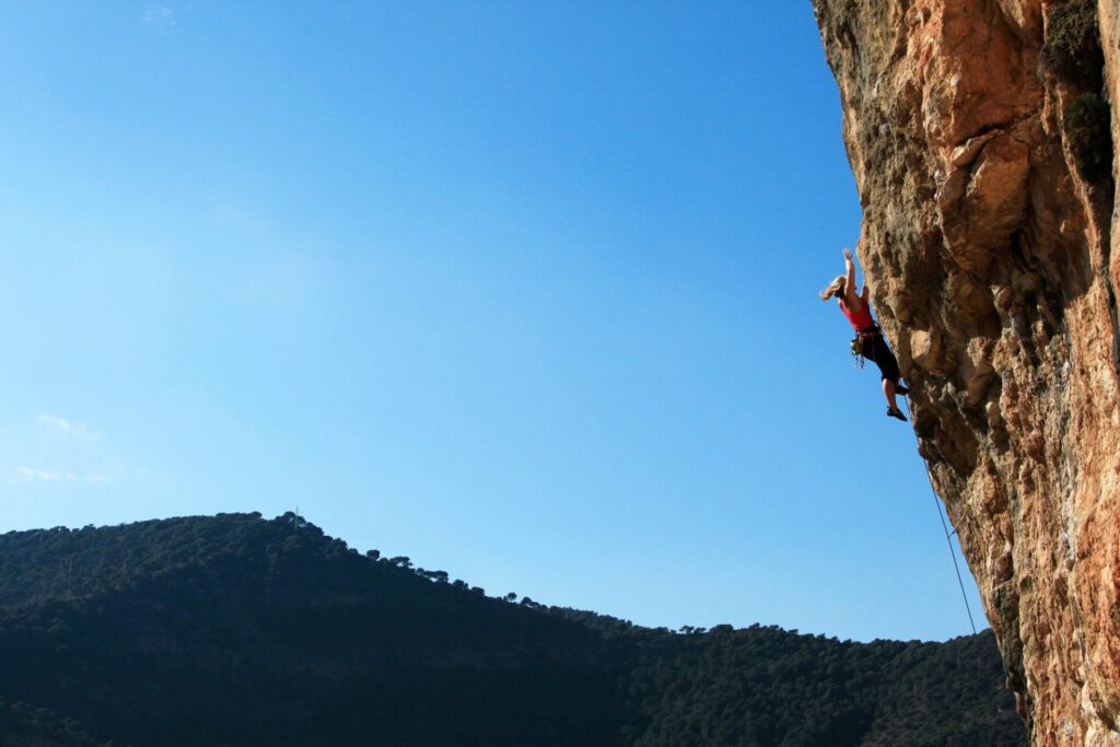 Hazel sport climbing in El Chorro, Andalucia, Spain. In this image she is making the crux move of Life Will Never End (7c) on the Los Tigres sector of the Makinodromo, one of the best cliffs in Europe for high level sport climbing.