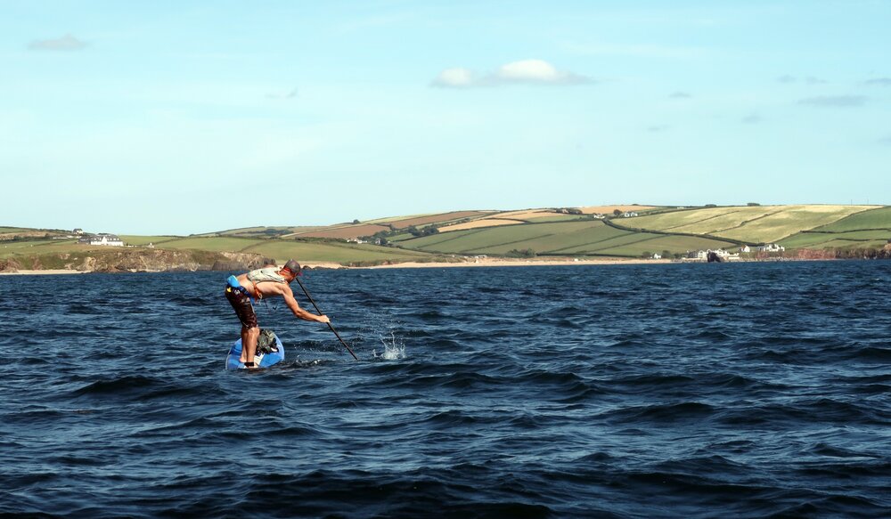 Gavin Symonds find the point of balance in a following sea in Bigbury Bay, South Devon.