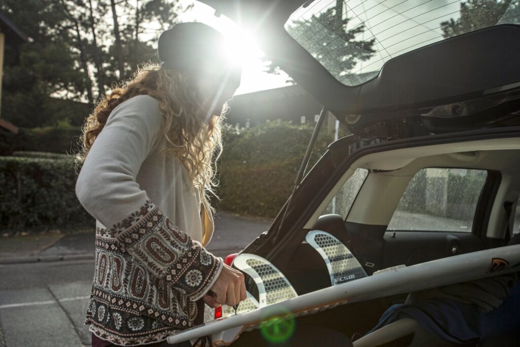 Justine making tweaks to her fin set up in the back of her 4X4 at home in southwest France. © Dom Daher / Red Bull