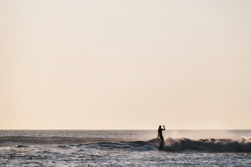 Bri stylish as ever on a sunset swell at Pea Island Nature Reserve on the Cape Hatteras National Seashore in the heart of The Outer Banks.