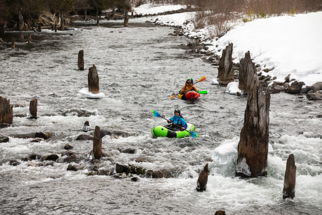 Packrafting the Cheakamus River with gear-stuffed boats.