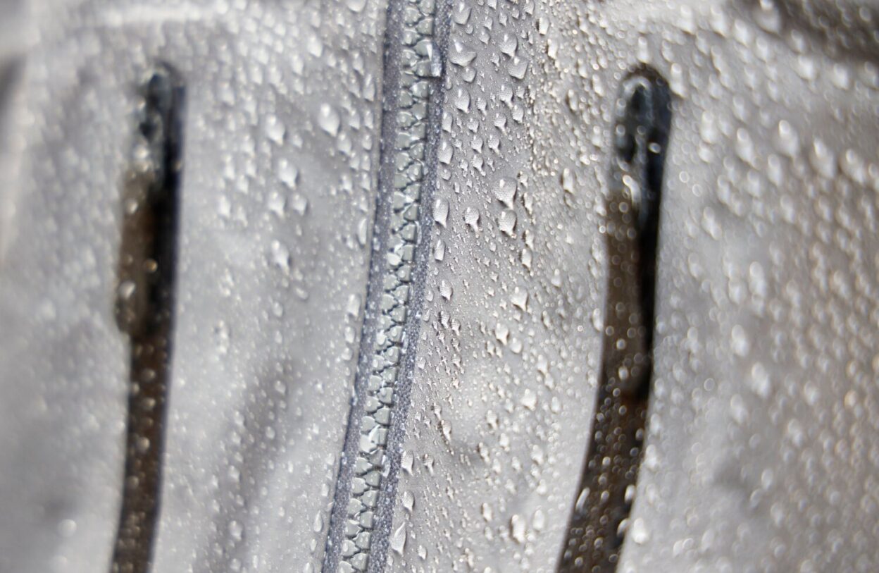 The water droplets ‘beading’, on the face fabric and front zipper of an Arc’teryx Beta AR hardshell. © David Pickford