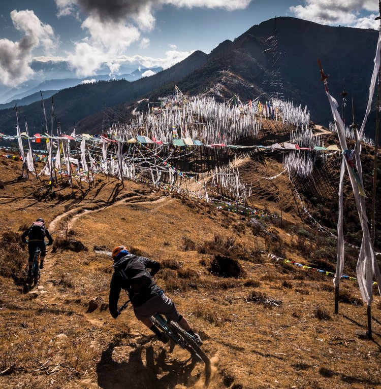 Euan and Sam steer along the Cheela trail towards a vast stand of darshen – white prayer flags – that cover the ridge near the 3,988m high Cheela pass. These striking vertical flags, sometimes four or five metres tall, are typically planted 108 in number following the death of a relative. ‘Planting them is the hardest part of when someone dies,’ jokes Yeshten, the team’s second local guide.
