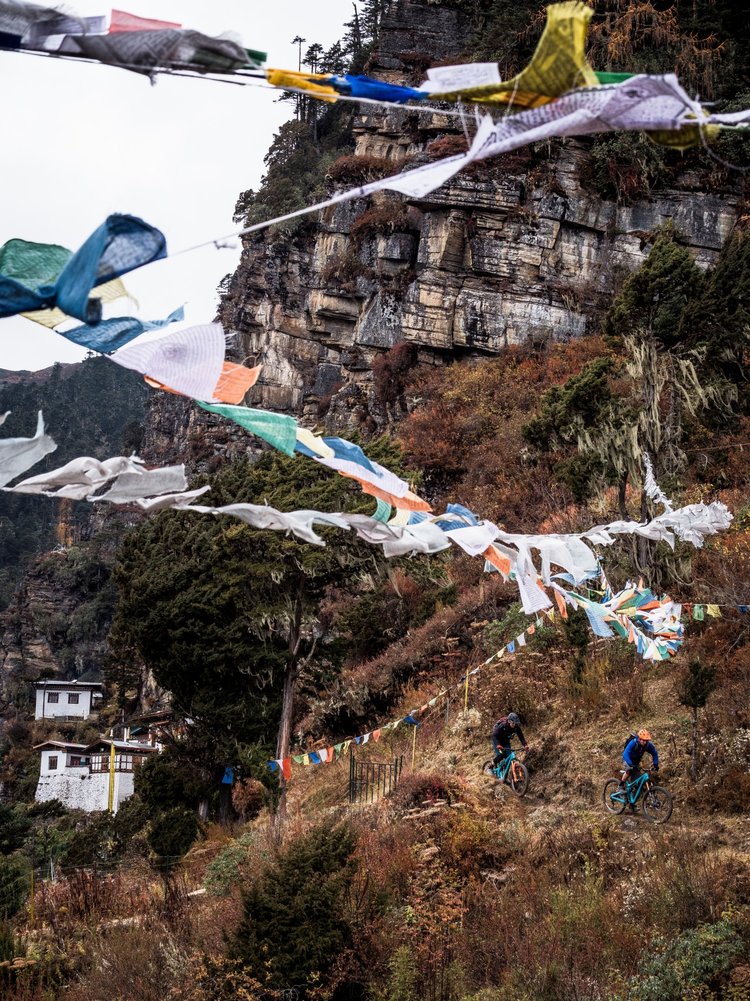 Modern Bhutan is a place of contrast, and no more so than in its relatively recent embrace of modern tourism. Here Euan and Sam pedal state of the art bikes away from the one thousand year old Kila nunnery, towards the most flowing descent of their trip. Tourism is now Bhutan’s second largest industry, after hydroelectric power.