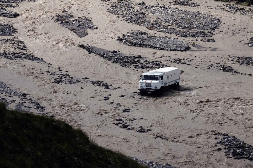 A Soviet-era ‘Shishiga’ truck crossing the swollen river en-route to Elbrus north side basecamp.