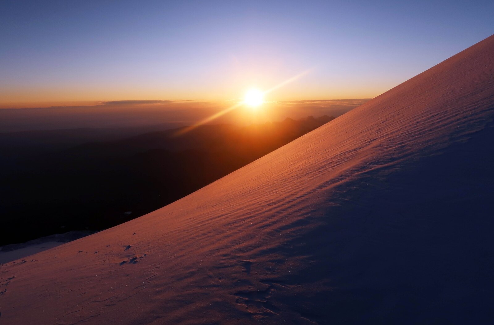 Sunrise at Lenz Rocks at 4500m during a summit push on Mount Elbrus. Although it was circa minus 20 Celsius (with windchill) when the photograph was taken, experiencing the rising sun in an environment like this is worth getting up at 12.30am for.