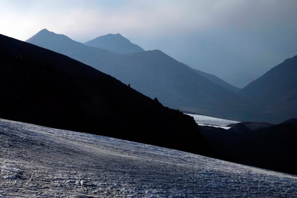 Looking west across Oulloulok glacier towards the lesser peaks of the western Russian Caucasus in late afternoon light.